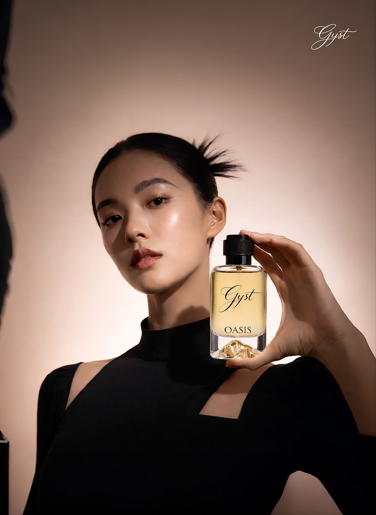 Model holding GYST OASIS eau de parfum in warm light