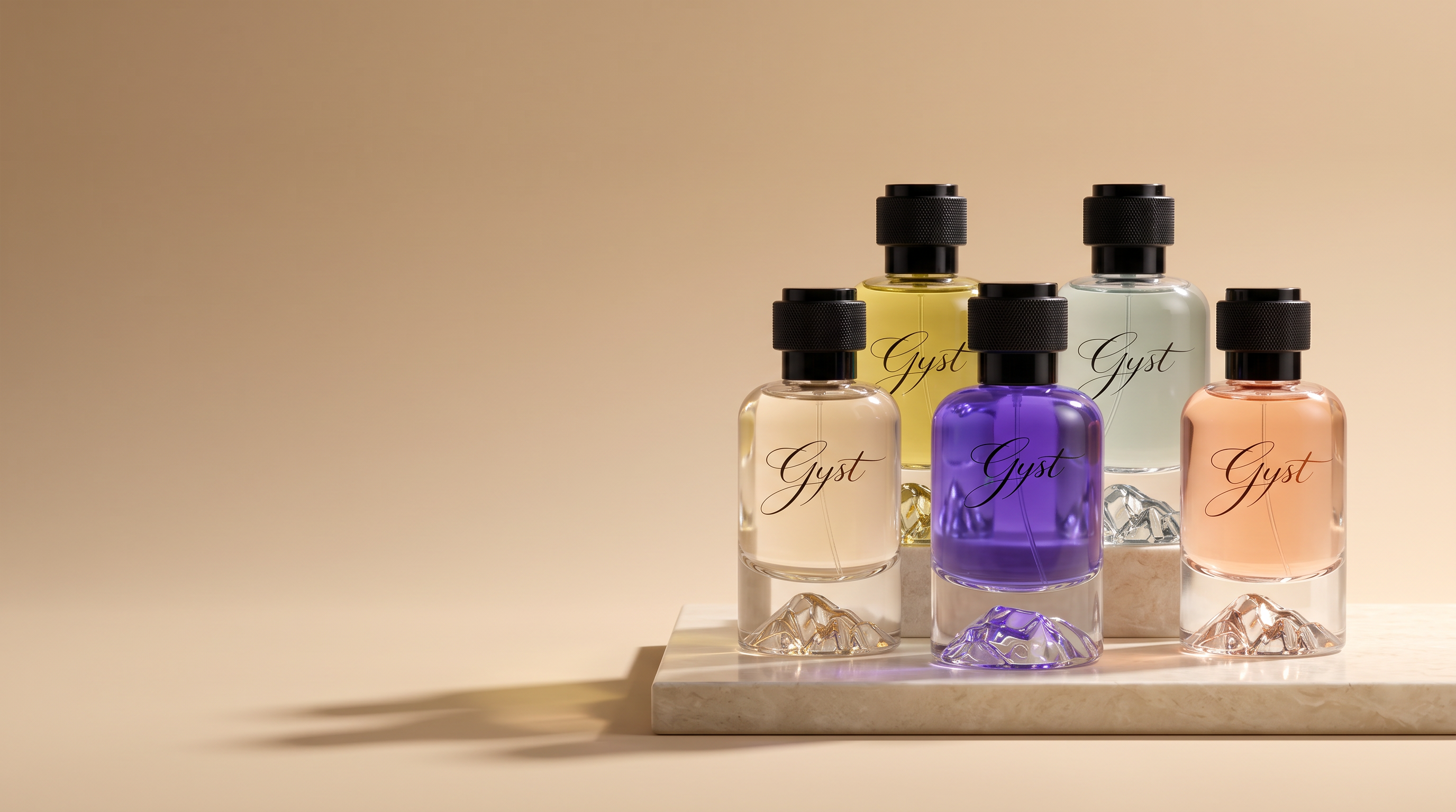 Five GYST eau de parfum bottles with sculpted mountain-peak bases grouped on a cream stone slab against a warm sand backdrop, soft studio light